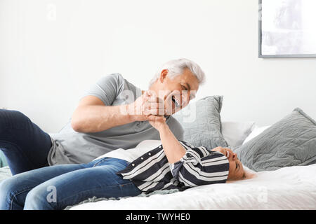 Portrait of mature couple having fun at home Stock Photo