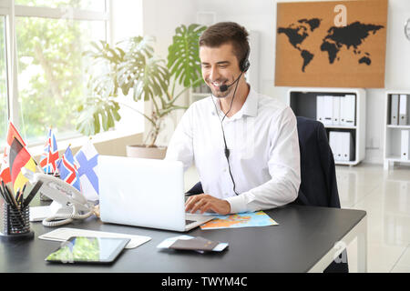 Male travel agent working in office Stock Photo