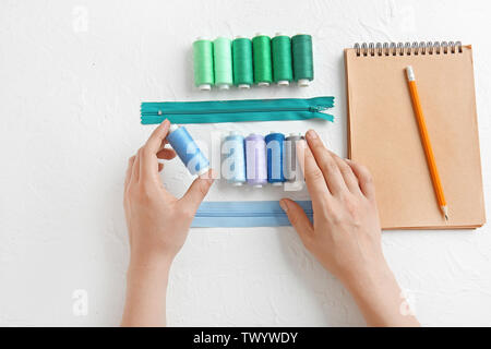 Female hands with notebook and accessories on white background Stock Photo