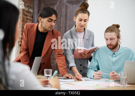 Portrait of multi-ethnic business team collaborating on project n modern office, copy space Stock Photo