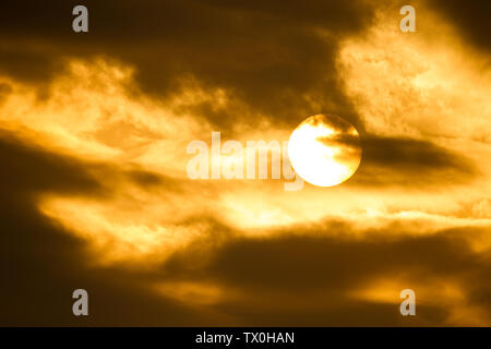 The sun setting behind clouds in Kanagawa, Japan. Stock Photo
