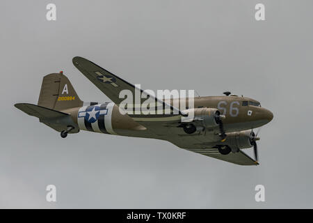 A Douglas C-47 Skytrain WW2 transport aircraft in the sky above Dunsfold Aerodrome, UK for the last ever Wings & Wheels airshow on the 16th June 2019. Stock Photo