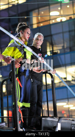 New York, USA. 23rd June, 2019. Lijana Wallenda prepares to take her first steps on a record-breaking high wire walk with her brother over Times Square, 25 stories in the air.  Lijana suffered a near-fatal fall less than two years ago. Credit: Tim Boyles/Alamy Live News Stock Photo