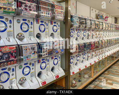 A row of Gachapon or 'toy-in-a-capsule' vending machines, popular with kids and teens in Japan. Stock Photo