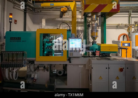 DUBAI, UAE, JANUARY 09, 2019: Plastic injection molding machine in the process of creating a brick Lego in Legoland Stock Photo