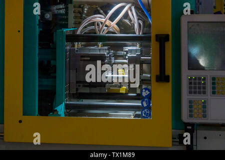DUBAI, UAE, JANUARY 09, 2019: Process of forming bricks Lego using the plastic injection molding machine in Legoland Stock Photo