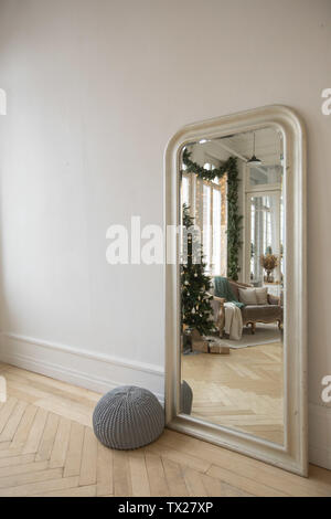 Mirror against wall reflecting interior of room Stock Photo