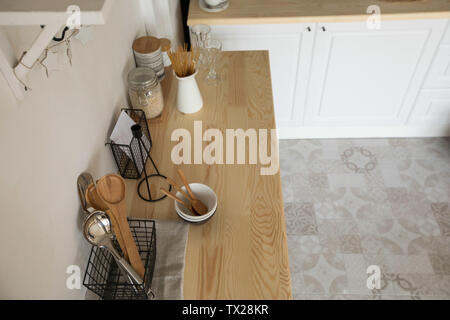 Various kitchen utensils and pasta on wooden table Stock Photo