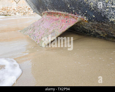 Sailing boat on the beach leans on the keel. Selective focus. Stock Photo
