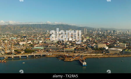 Aerial view of panorama of the city of Cebu with skyscrapers and buildings during sunrise. Philippines. Stock Photo