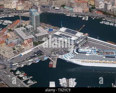 Aerial view of the Port of Savona, with docks and the cruise ship Costa Fascinosa on anchor at the Palacrociere Terminal in the 'Darsena Nuova'. Stock Photo
