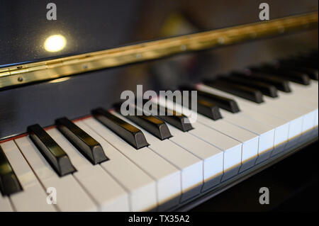 Close-up piano keyboard instrument with shining background. selective focus Stock Photo