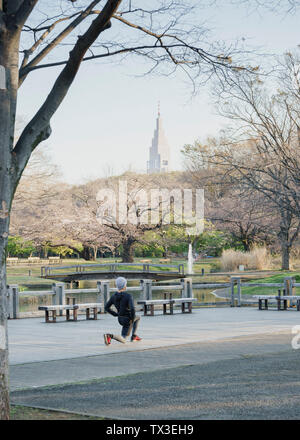 Runner stretching in Yoyogi Park, Shibuya, Tokyo, Japan Stock Photo
