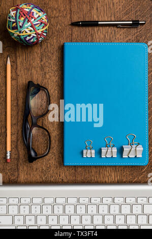View from above organized office supplies on wooden desk - knolling Stock Photo