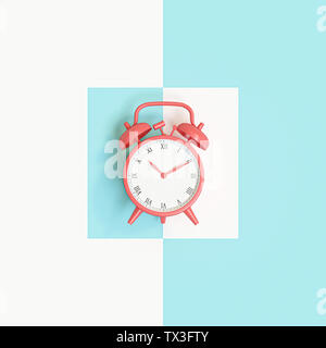 3d image render of a classic coral alarm clock on a blue and white background Stock Photo