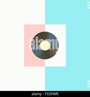 3d render image of a classic vinyl record on a light blue, pink and white background in a flat lay style. Stock Photo