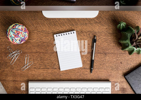 View from above blank notepad in front of desk Stock Photo