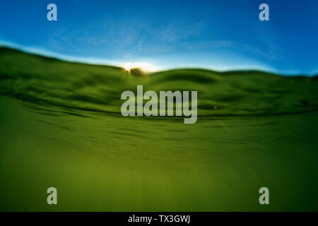 Sunlight streaming through ocean water Stock Photo