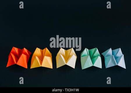 Rainbow multicolored origami fortune tellers on black background Stock Photo