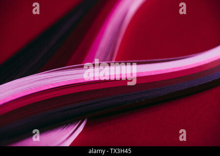 Abstract rainbow paper wave pattern on red background Stock Photo