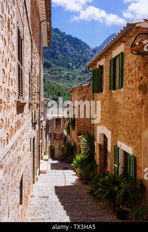 Sunny cobblestone street and houses, Fornalutx, Mallorca, Balearic Islands, Spain Stock Photo