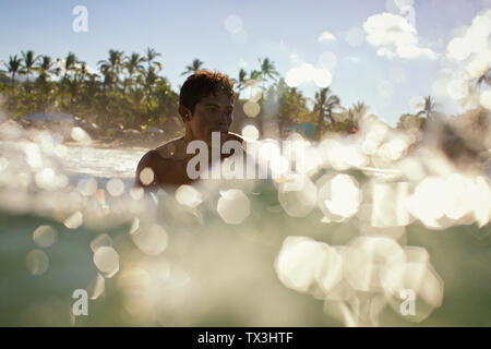 Young man swimming in sunny, tropical ocean, Sayulita, Nayarit, Mexico Stock Photo