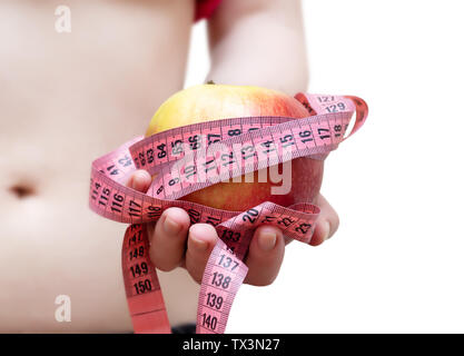 Apples with measure tape in female hand. Stock Photo