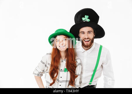 Cheerful young couple standing isolated over white background, celebrating St.Patrick 's Day Stock Photo