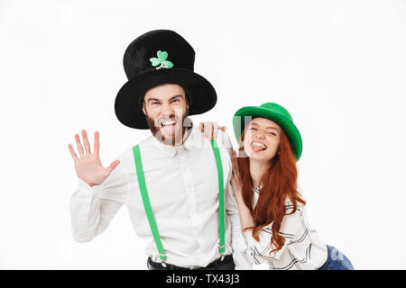 Cheerful young couple standing isolated over white background, celebrating St.Patrick 's Day Stock Photo