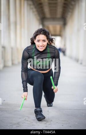 Smiling young woman doing pound fitness exercise Stock Photo