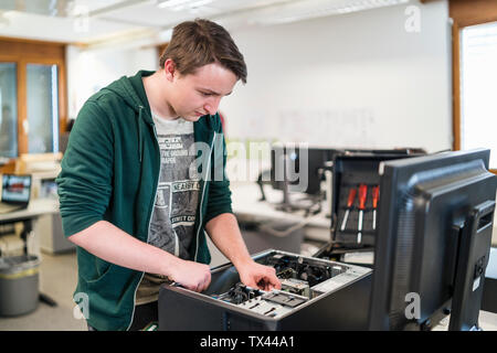 Teenager assembling personal computer Stock Photo