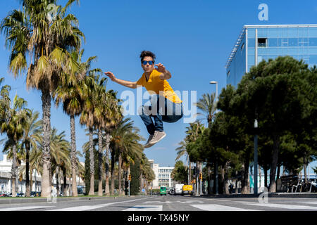 Spain, Barcelona, man in the city jumping on the street Stock Photo