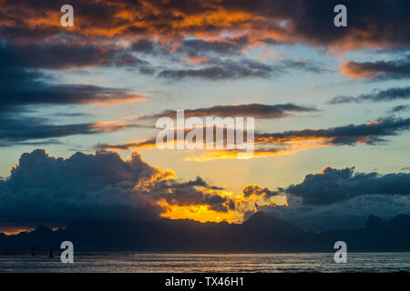 French Polynesia, Tahiti, dramatic sunset over Moorea Stock Photo