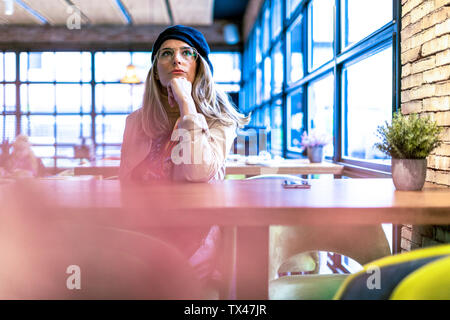 Serious woman in a cafe Stock Photo