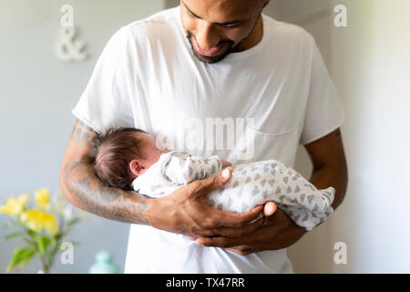 Father holding his sleeping newborn baby Stock Photo