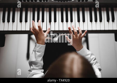 Top view of a girl playing synthesizer Stock Photo