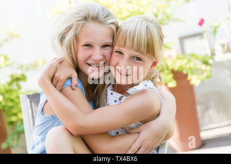 Portrait of two girls hugging Stock Photo - Alamy