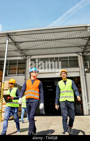 Workers walking on factory yard Stock Photo
