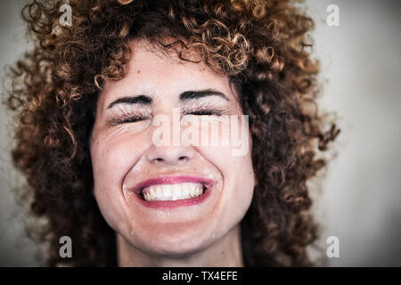 Portrait of sweating woman with curly hair Stock Photo