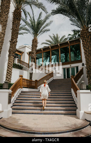 United Arab Emirates, Dubai, Lahbab Desert, woman walking on oriental stairs at a resort Stock Photo