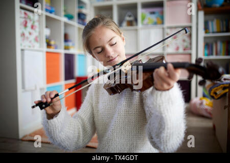 Girl exercising on her violin Stock Photo