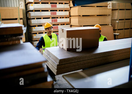 Two workers in factory warehouse Stock Photo