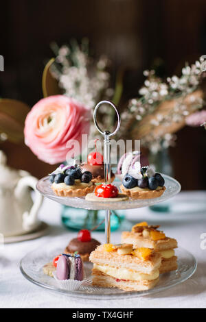 Various pastries on glass cake stand Stock Photo