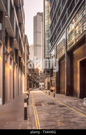 UK, London, narrow street in the City of London financial district with skyscrapers in the background Stock Photo