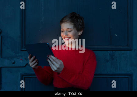 Portrait of smiling businesswoman using digital tablet at twilight Stock Photo