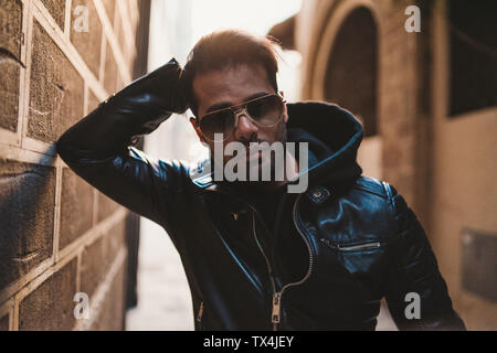 Portrait of bearded man wearing sunglasses and black leather jacket Stock Photo