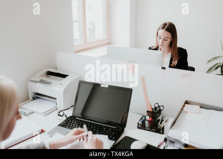 Two young women working at desk in office Stock Photo