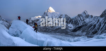 Nepal, Solo Khumbu, Mountaineers at Everest Icefall, Pumori in background Stock Photo