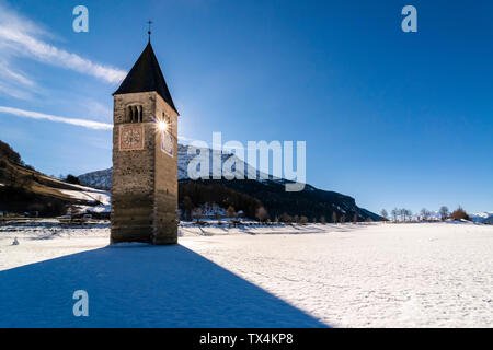 Italy, Venosta Valley, Sunken spire in frozen Lago di Resia in winter Stock Photo