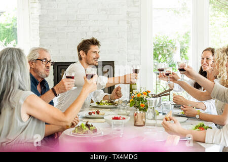 Hapüpy family celebrating together, clinking glasses Stock Photo